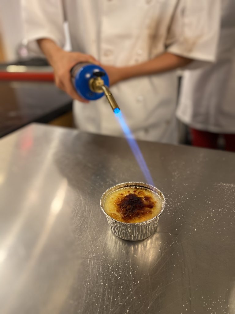 creme brulee fun at cooking camp Denver.