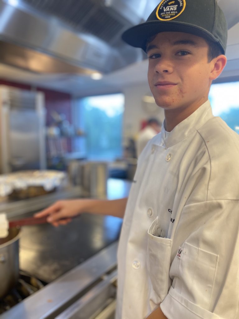 A dude having fun at cooking camp Denver.